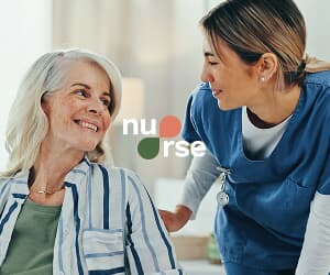 Caregiver speaking with smiling senior woman